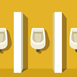 Urinals against a yellow window